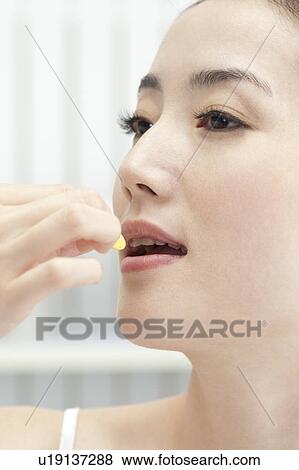 Beauty Treatment, Close-up of woman's face and taking medicine View Large Photo Image Stock Photo - Beauty Treatment, Close-up of woman's face and taking medicine. Fotosearch