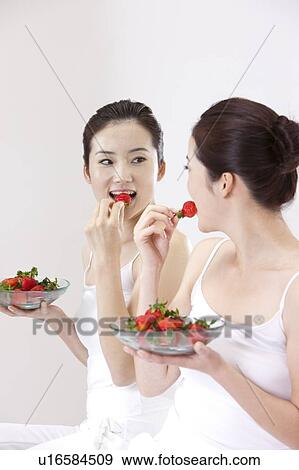 Beauty Treatment, Woman looking at the mirror and eating a plate of strawberry View Large Photo Image Stock Photo - Beauty Treatment, Woman looking at the mirror and eating a plate of strawberry. Fotosearch