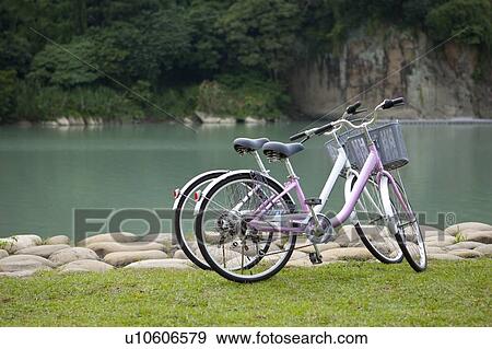 Bicycle, Two bicycles near the lake View Large Photo Image Stock Photo - Bicycle, Two bicycles near the lake. Fotosearch