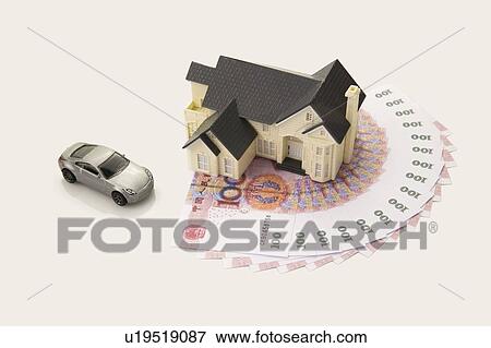 Chinese Currency, a model house and a toy car View Large Photo Image Stock Photo - Chinese Currency, a model house and a toy car. Fotosearch