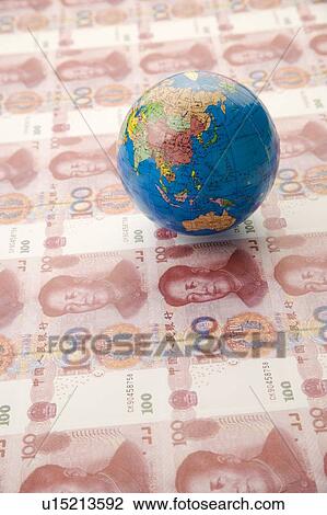 Stock Image - Chinese Currency and a globe of world map. Fotosearch