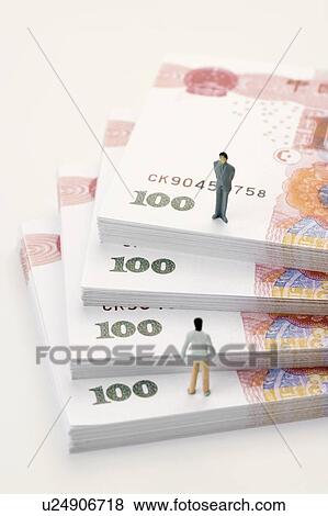 Chinese Currency, two figurine men standing on top of stacks of paper money View Large Photo Image Stock Photo - Chinese Currency, two figurine men standing on top of stacks of paper money. Fotosearch