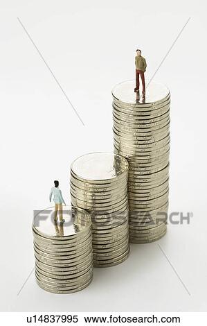 Stock Photography - Chinese Currency, two figurine men standing on top of stacks of coins, one standing higher than the other. Fotosearch