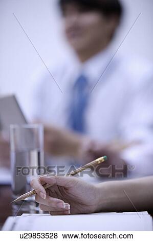 Stock Photo - Close-up of a hand holding a pencil. Fotosearch