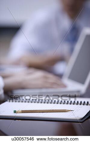Close-up of a pencil on a notebook View Large Photo Image Stock Photograph - Close-up of a pencil on a notebook. Fotosearch