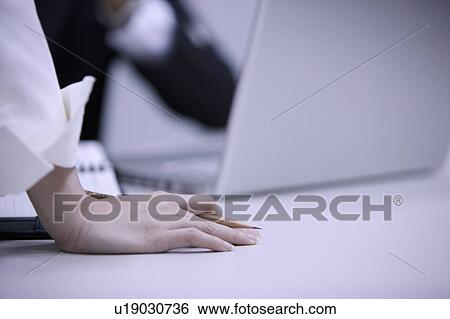 Stock Photograph - Close-up of human's hands holding a pencil. Fotosearch