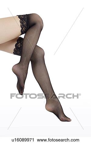 Stock Image - Close-up of young woman wearing a sexy stockings. Fotosearch