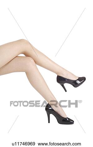 Stock Photo - Close-up of young woman's legs with high heels. Fotosearch