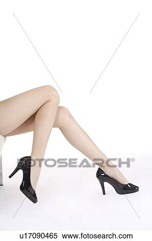 Stock Photography - Close-up of young woman's legs with high heels. Fotosearch