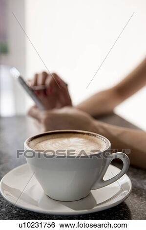 Stock Photograph - Coffee Break, Close-up of a cup of cappuccino with pattern. Fotosearch