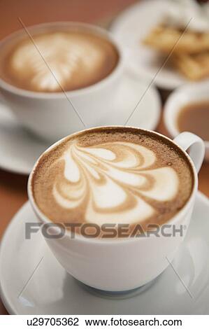 Stock Image - Coffee, Cappuccino, Close-up of cups of cappuccino with pattern. Fotosearch