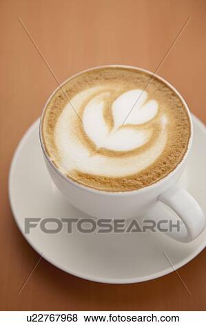 Stock Photo - Coffee, Close-up of a cup of cappuccino with pattern on the table. Fotosearch