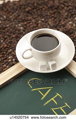 Coffee, Close-up of a cup of coffee above a stack of coffee beans View Large Photo Image Picture - Coffee, Close-up of a cup of coffee above a stack of coffee beans. Fotosearch