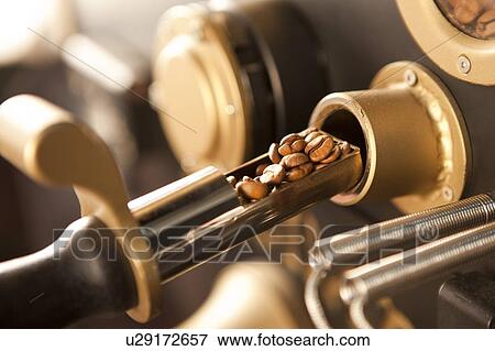 Stock Photo - Coffee Culture, Close-up of coffee beans on the roasting machine. Fotosearch