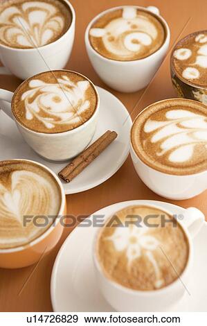 Stock Photo - Coffee, Cups of cappuccino with different patterns on the table. Fotosearch