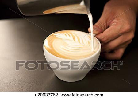 Stock Image - Coffee, People making a cup of coffee with a pattern. Fotosearch