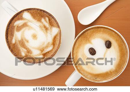 Coffee, Two cups of cappuccino with different pattern on the table View Large Photo Image Stock Photo - Coffee, Two cups of cappuccino with different pattern on the table. Fotosearch