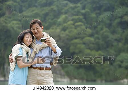 Couple, Couple bonding together and taking pictures View Large Photo Image Stock Image - Couple, Couple bonding together and taking pictures. Fotosearch