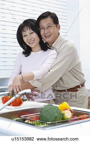 Stock Image - Couple, Couple bonding together and looking at the camera with smile. Fotosearch