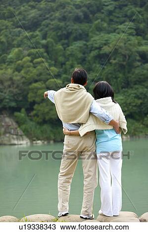 Stock Image - Couple, Couple bonding together and looking away. Fotosearch