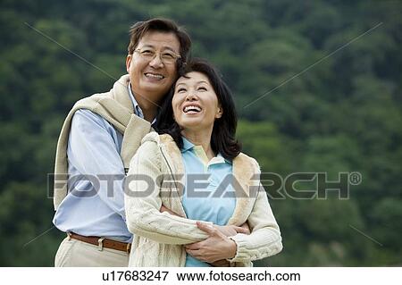 Stock Photo - Couple, Couple bonding together and looking up with smile. Fotosearch