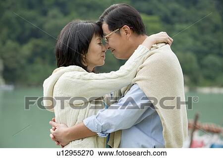 Stock Image - Couple, Couple embracing with smile. Fotosearch