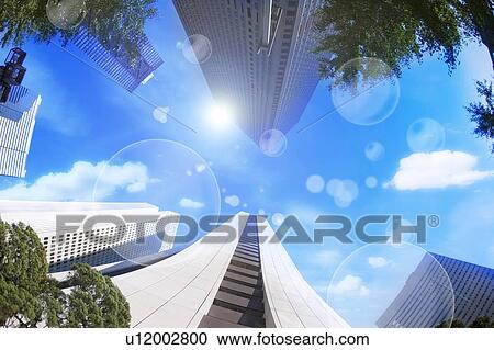 Stock Image - Environmental Conservation, Digitally generated image of buildings and plants in the blue sky. Fotosearch