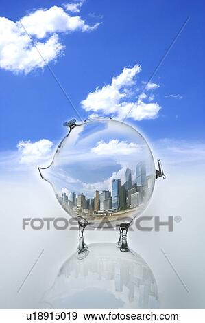 Stock Photo - Environmental Conservation, Digitally generated image of buildings in a piggy bank with blue sky in background. Fotosearch