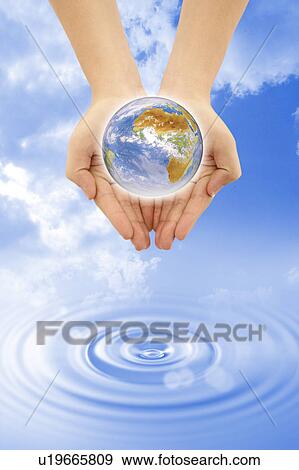 Environmental Conservation, Digitally generated image of human hands holding the earth View Large Photo Image Stock Photo - Environmental Conservation, Digitally generated image of human hands holding the earth. Fotosearch