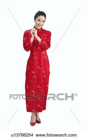 Picture - New Year, Young woman wearing Chinese traditional clothing and greeting with smile. Fotosearch