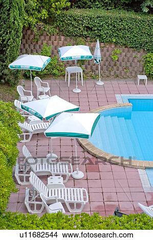 Picture - Sunshade, Chair, Table, Swimming Pool. Fotosearch
