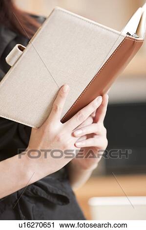 Woman holding a notebook View Large Photo Image Stock Image - Woman holding a notebook. Fotosearch