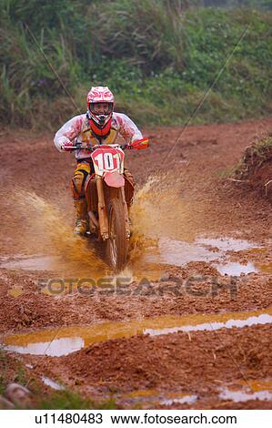 Young man motocross over field. View Large Photo Image Stock Image - Young man motocross over field.. Fotosearch