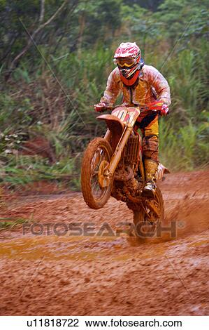 Stock Image - Young man motocross over field.. Fotosearch