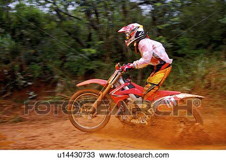 Young man motocross over field. View Large Photo Image Stock Image - Young man motocross over field.. Fotosearch