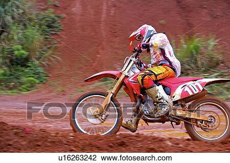 Young man motocross over field. View Large Photo Image Stock Image - Young man motocross over field.. Fotosearch