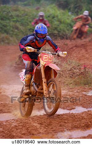 Young man motocross over field. View Large Photo Image Stock Image - Young man motocross over field.. Fotosearch