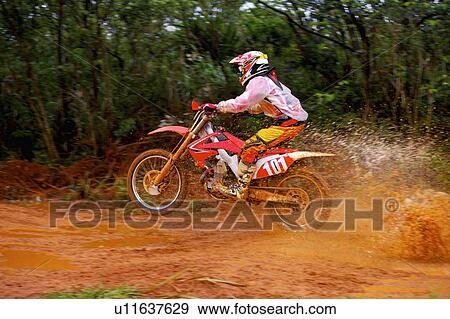 Young man motocross over field. View Large Photo Image Stock Photo - Young man motocross over field.. Fotosearch