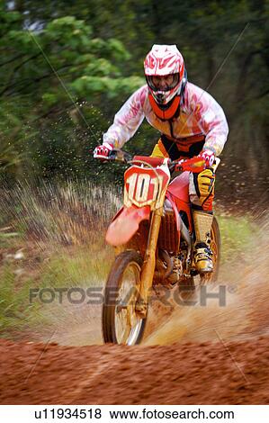Stock Photo - Young man motocross over field.. Fotosearch