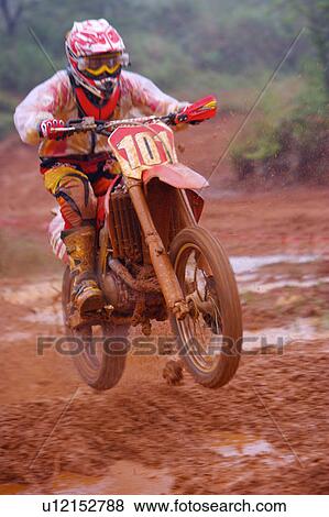 Young man motocross over field. View Large Photo Image Stock Photo - Young man motocross over field.. Fotosearch