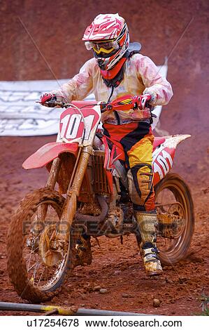 Stock Photo - Young man motocross over field.. Fotosearch