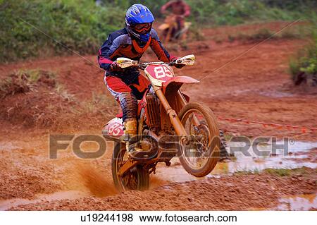 Young man motocross over field. View Large Photo Image Stock Photo - Young man motocross over field.. Fotosearch