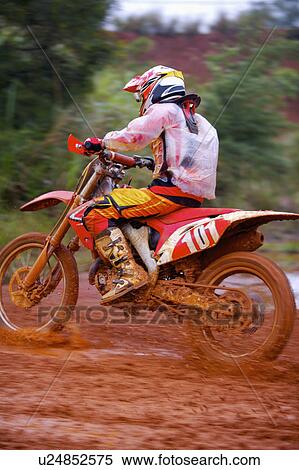 Stock Photography - Young man motocross over field.. Fotosearch