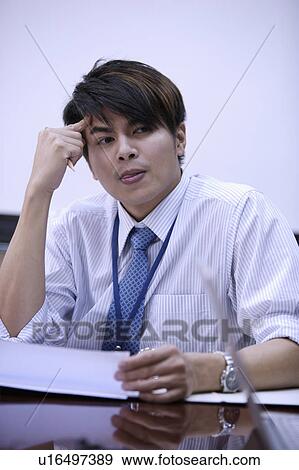 Young man thinking and looking away with hand in hair View Large Photo Image Stock Photo - Young man thinking and looking away with hand in hair. Fotosearch