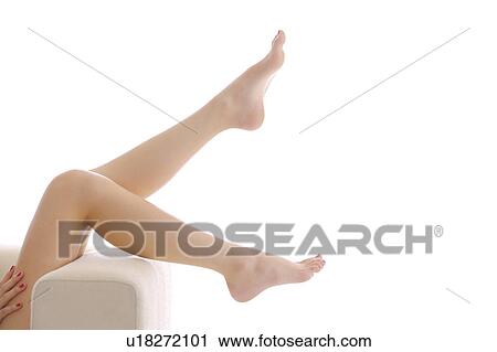 Stock Image - Young woman making legs apart in mid-air. Fotosearch