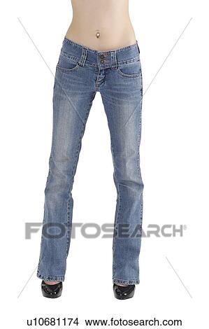 Picture - Young woman standing and wearing jeans. Fotosearch