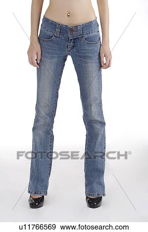 Stock Photo - Young woman wearing jeans and high heels. Fotosearch