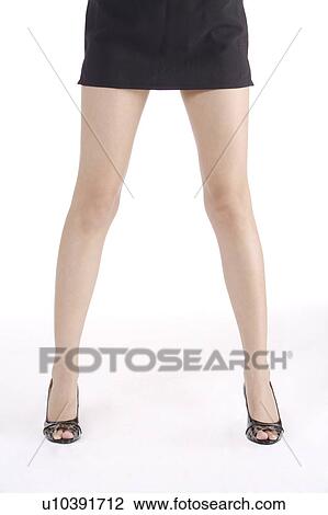 Young woman wearing miniskirt and high heels View Large Photo Image Stock Image - Young woman wearing miniskirt and high heels. Fotosearch