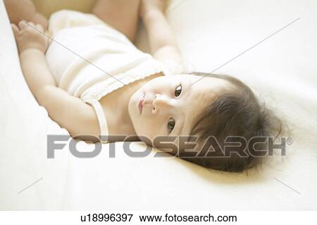 A baby lying View Large Photo Image Stock Photo - A baby lying. Fotosearch