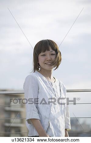 Picture - A young woman smiling. Fotosearch